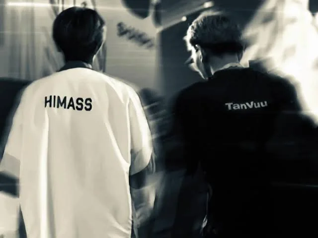 Hai tuyển thủ Himass và TanVuu quay lưng, trên áo in tên HIMASS và TanVuu, ảnh đen trắng