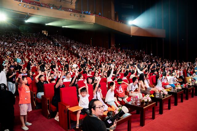 Các bạn nhỏ giơ tay trong khán phòng “Chắp cánh tuổi thơ”